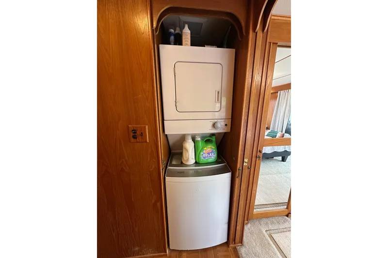 Slide: The Image of Compact laundry area in a 1990 Lazy Days 14x72 mobile home with stacked washer and dryer. - 9