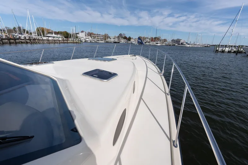 Slide: The Image of 2016 Palm Beach Motor Yachts PB50 on calm waters, marina in background. - 21