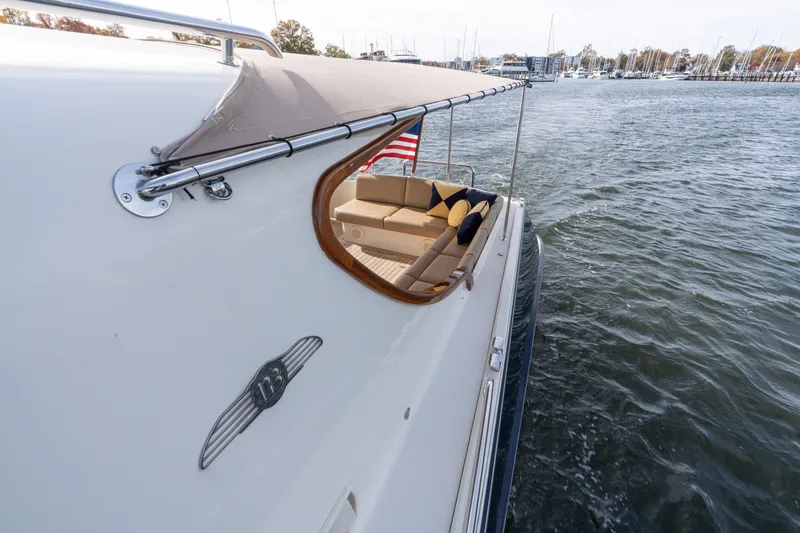Slide: The Image of 2016 Palm Beach Motor Yachts PB50 cruising on water, featuring elegant seating and canopy. - 30