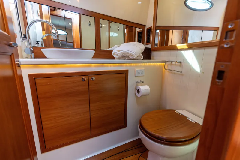 Slide: The Image of Luxurious 2016 Palm Beach Motor Yachts PB50 bathroom with wood accents and modern fixtures. - 58
