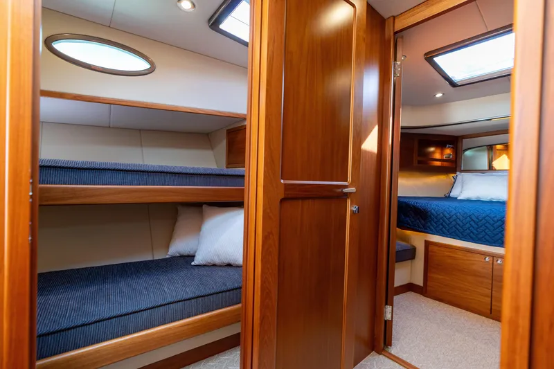 Slide: The Image of Luxurious 2016 Palm Beach Motor Yachts PB50 interior with cozy wooden cabin and bunk beds. - 61