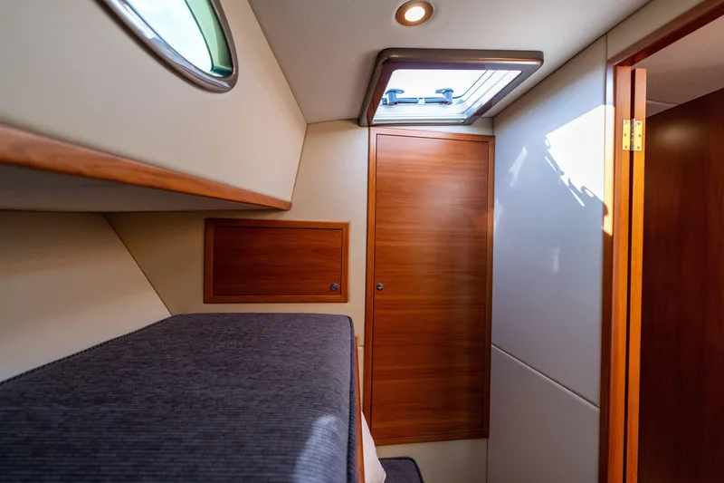 Slide: The Image of 2016 Palm Beach Motor Yachts PB50 cabin interior with wood paneling and skylight. - 64