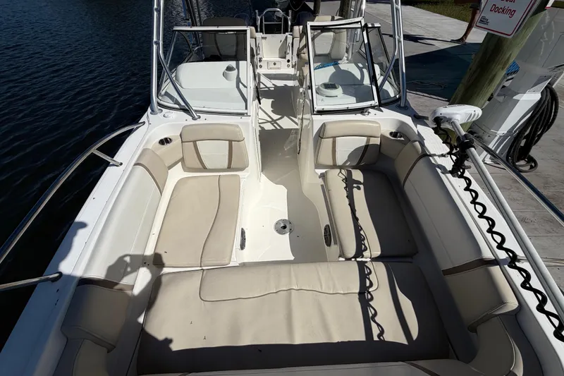 Slide: The Image of 2017 World Cat 255 DC boat interior with beige seating and open deck layout. - 10