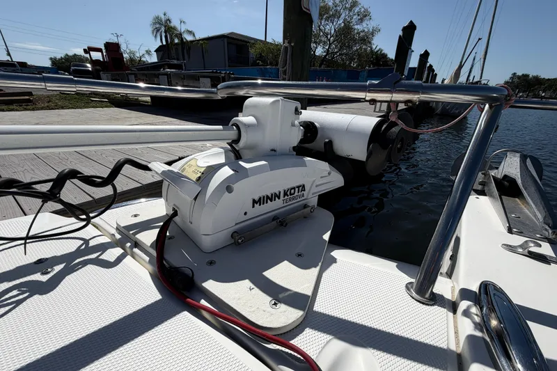 Slide: The Image of Minn Kota Terrova motor on 2017 World Cat 255 DC boat docked by the water. - 12