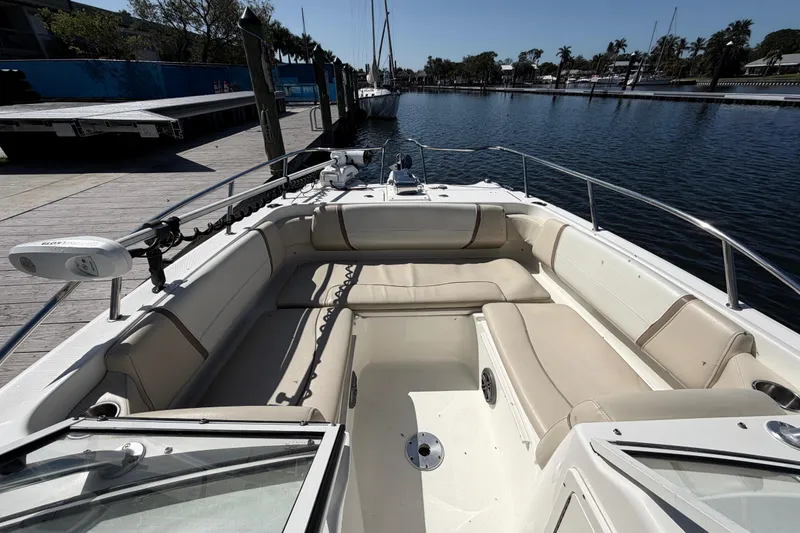 Slide: The Image of 2017 World Cat 255 DC boat with spacious seating, docked by a serene waterfront. - 13