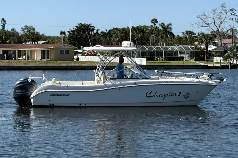 Slide: The Image of 2017 World Cat 255 DC boat named "Chapter 2" on calm water. - 19