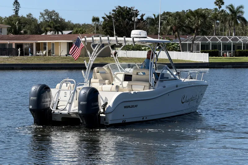 Slide: The Image of 2017 World Cat 255 DC boat cruising on a sunny day, featuring dual Yamaha engines. - 22
