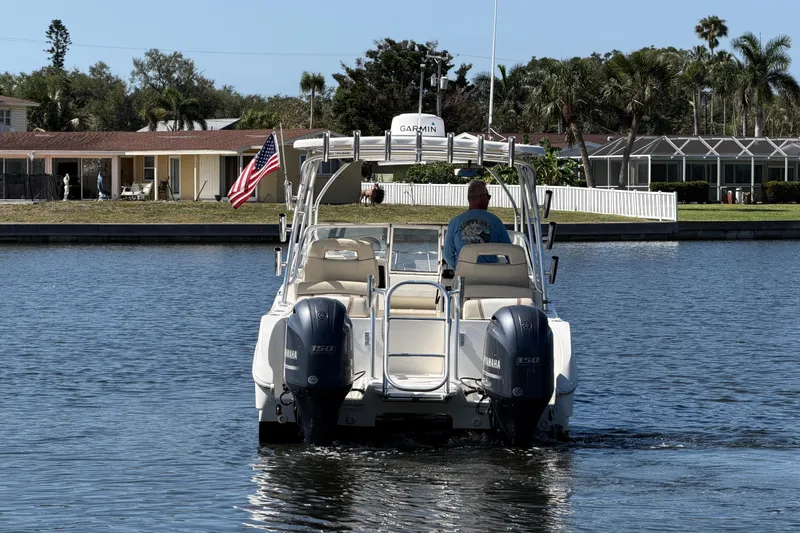 Slide: The Image of 2017 World Cat 255 DC boat cruising on a sunny day with American flag. - 23