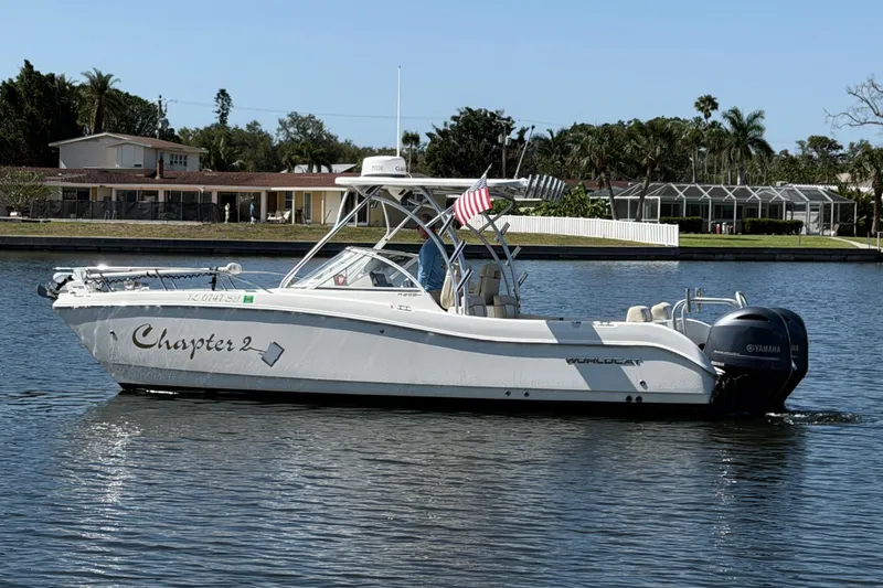 Slide: The Image of 2017 World Cat 255 DC boat named "Chapter 2" on a calm waterway. - 25