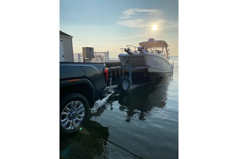 Slide: The Image of 2017 World Cat 255 DC boat being launched from a trailer at sunset. - 26