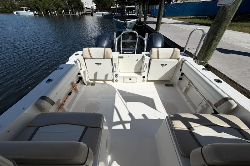 Slide: The Image of 2017 World Cat 255 DC boat interior with seating, docked by the water. - 4