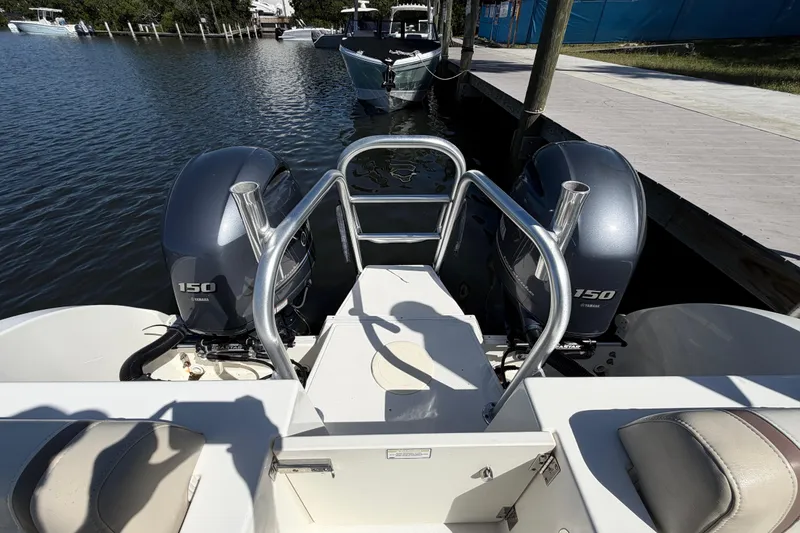 Slide: The Image of 2017 World Cat 255 DC boat with twin Yamaha 150 engines docked by the water. - 5