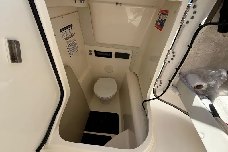 Slide: The Image of Interior view of a 2017 World Cat 255 DC boat's compact bathroom area. - 7