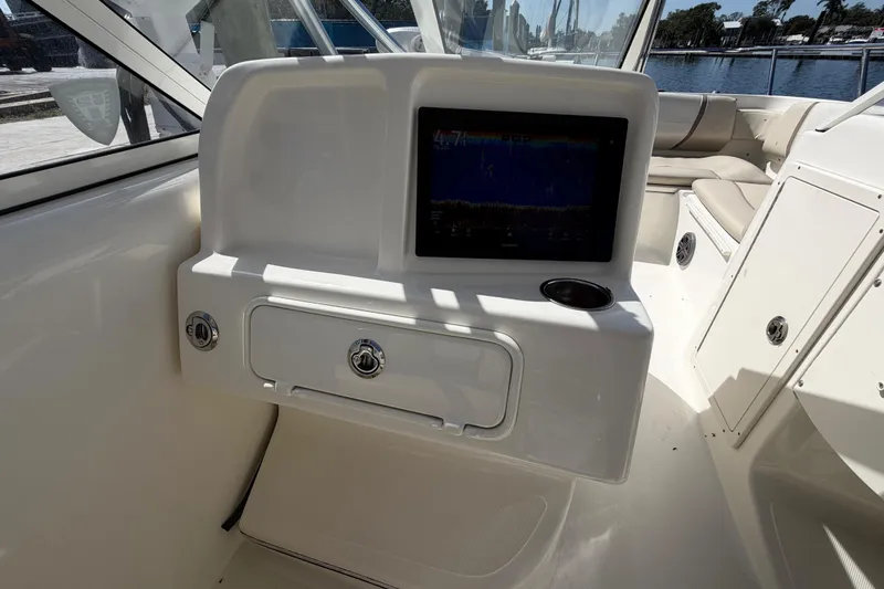 Slide: The Image of 2017 World Cat 255 DC boat interior with navigation screen and seating area. - 8