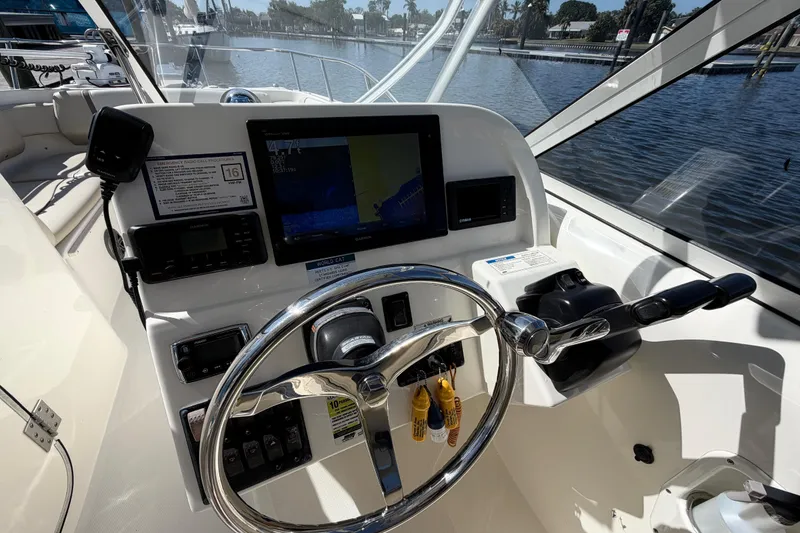 Slide: The Image of 2017 World Cat 255 DC boat dashboard with steering wheel and navigation display. - 9