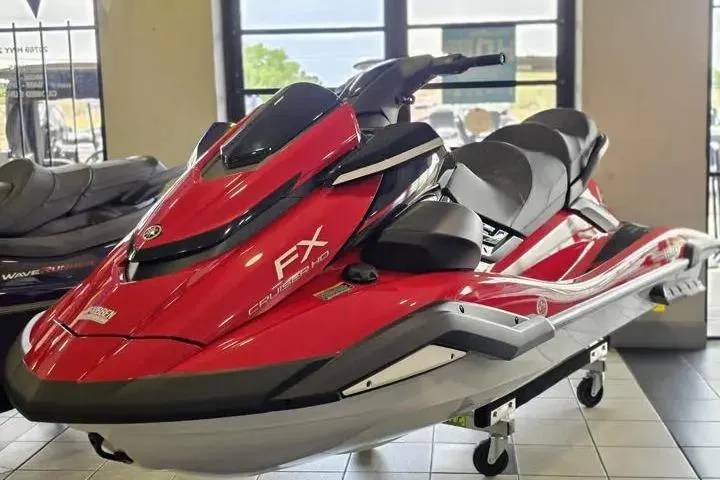 Slide: The Image of 2026 Yamaha WaveRunner FX Cruiser HO in showroom, red and black design, sleek and modern. - 2