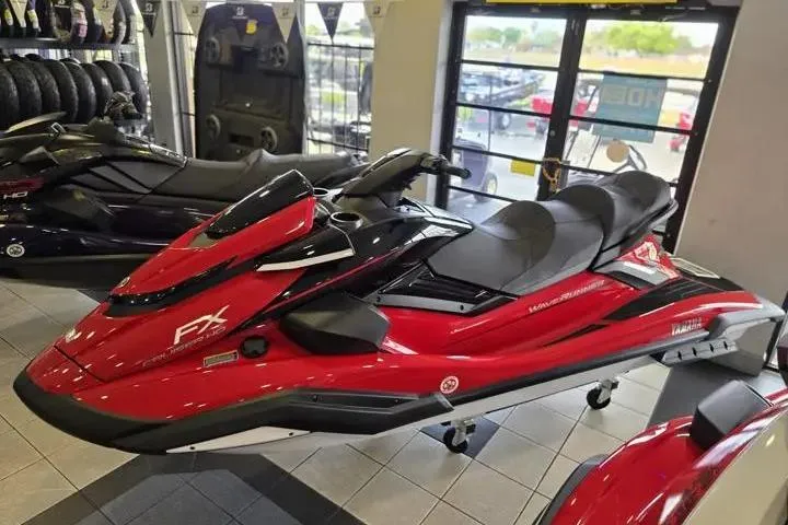Slide: The Image of 2026 Yamaha WaveRunner FX Cruiser HO in showroom, red and black design. - 3
