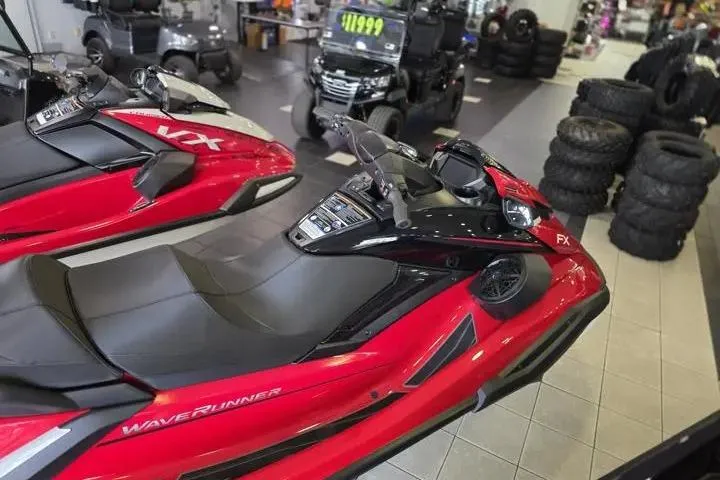 Slide: The Image of 2026 Yamaha WaveRunner FX Cruiser HO in showroom, red and black design, displayed with other vehicles. - 7
