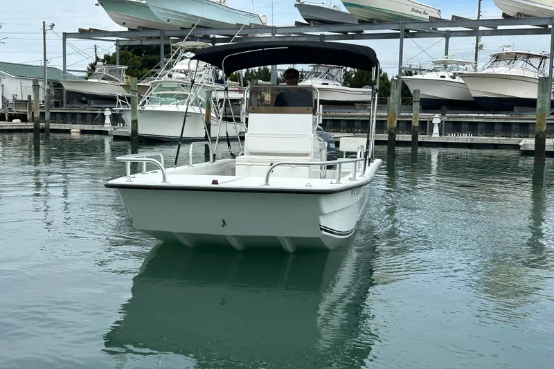 Slide: The Image of 2009 KenCraft 2060 boat docked in marina with multiple boats in background. - 10