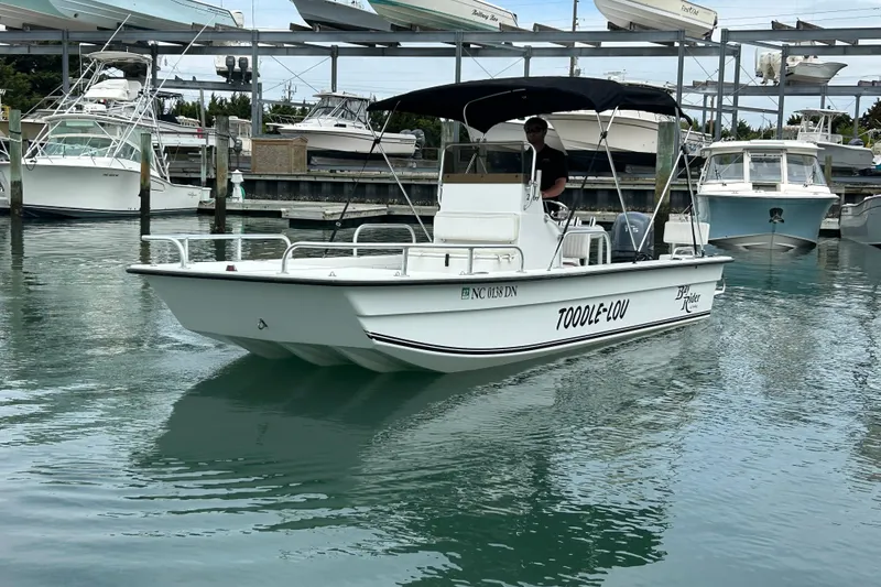 Slide: The Image of 2009 KenCraft 2060 boat named "Toodle-Lou" docked in a marina. - 12