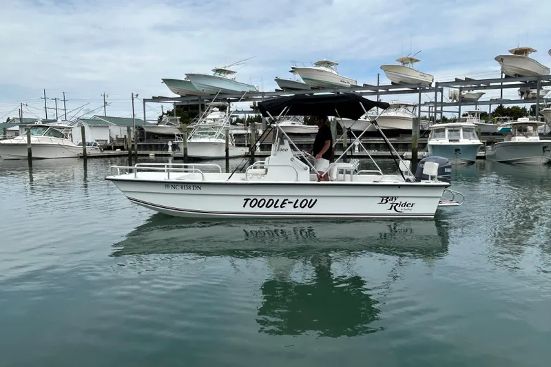 Slide: The Image of 2009 KenCraft 2060 Bay Rider boat docked in marina, labeled "TOODLE-LOU." - 13
