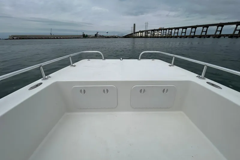 Slide: The Image of 2009 KenCraft 2060 boat deck with railing, overlooking calm waters and distant bridge. - 14
