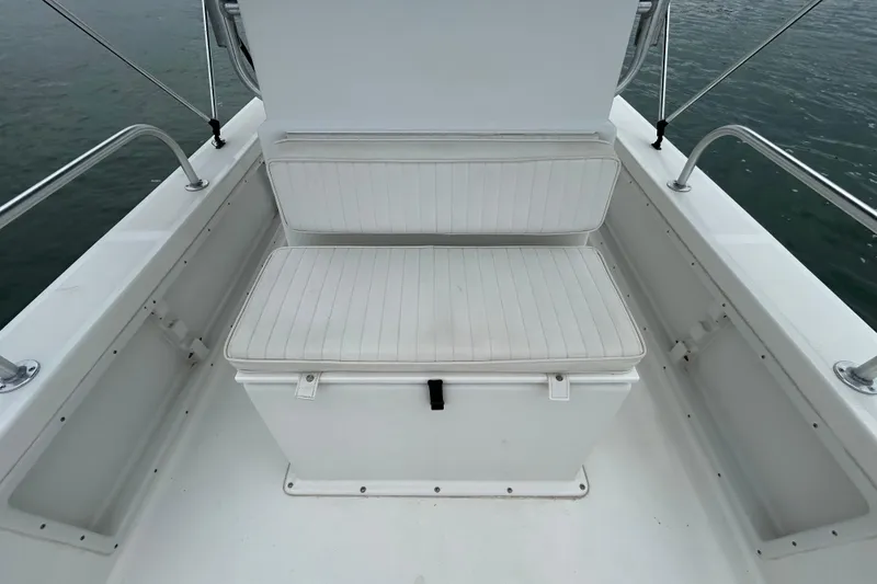 Slide: The Image of 2009 KenCraft 2060 boat with white cushioned seating on deck. - 17