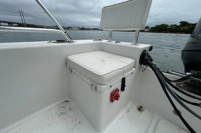 Slide: The Image of KenCraft 2060 boat interior, 2009 model, featuring a white cushioned seat and control panel by the water. - 21