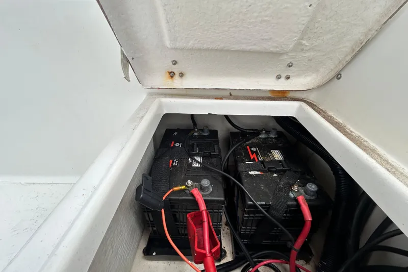 Slide: The Image of Battery compartment of a 2009 KenCraft 2060 boat with visible wiring. - 22