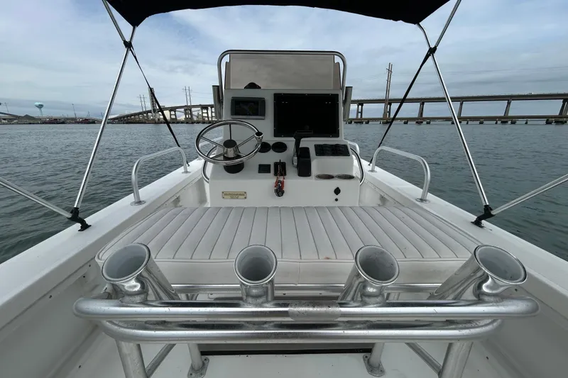 Slide: The Image of 2009 KenCraft 2060 boat interior with steering wheel, rod holders, and bridge view. - 25