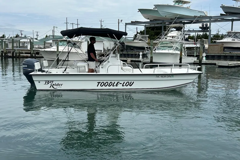 Slide: The Image of 2009 KenCraft 2060 Bay Rider boat named "TOODLE-LOU" docked in a marina. - 3