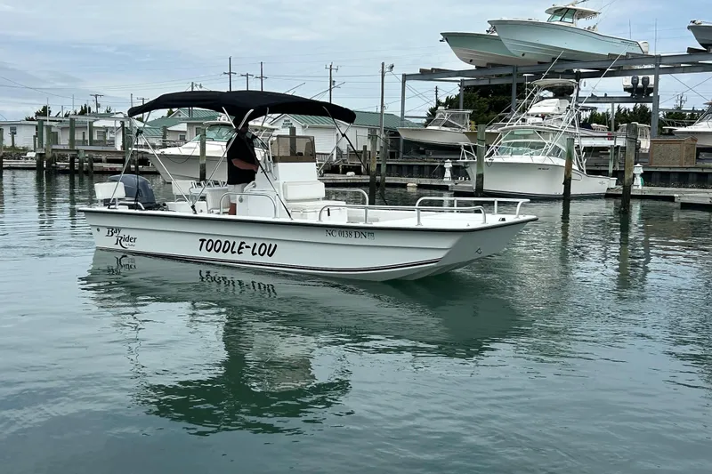 Slide: The Image of 2009 KenCraft 2060 boat named "Toodle-Lou" docked in a marina. - 4