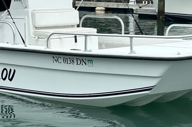 Slide: The Image of 2009 KenCraft 2060 boat docked, displaying registration number NC 0138 DN. - 5