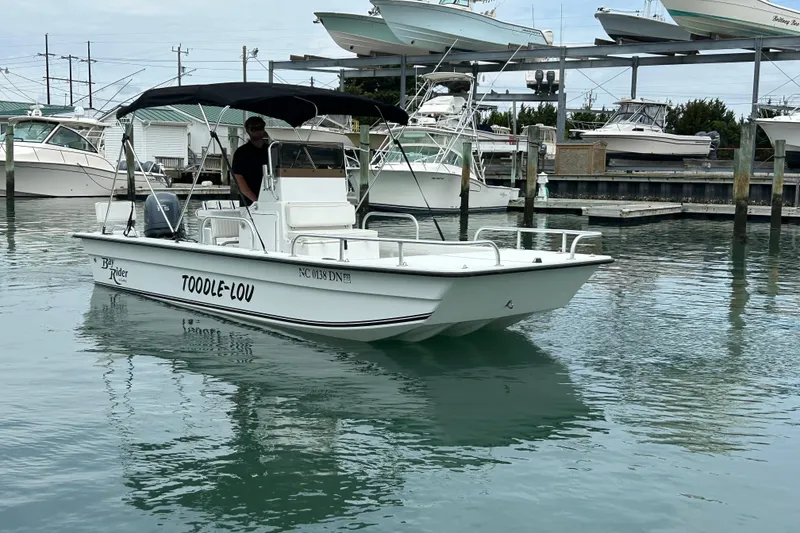 Slide: The Image of 2009 KenCraft 2060 boat named "TOODLE-LOU" docked in a marina. - 6