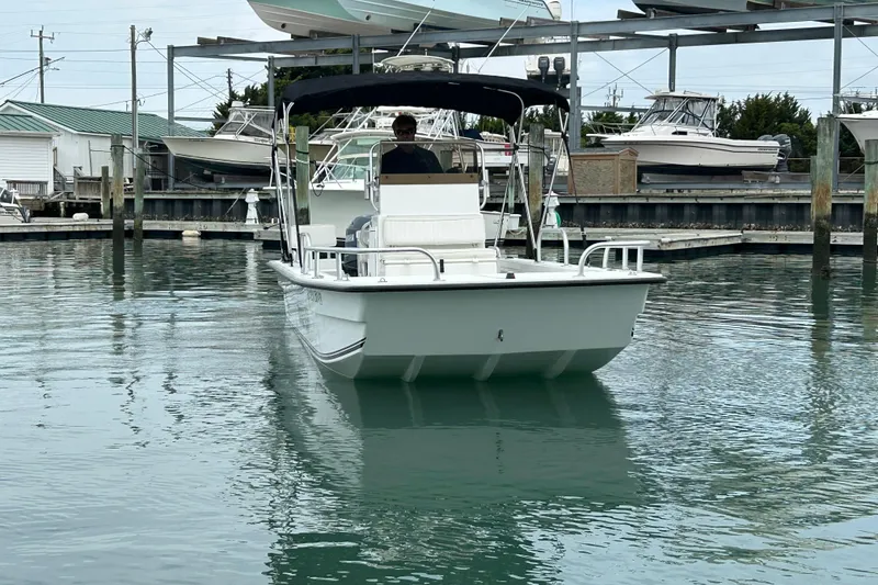 Slide: The Image of 2009 KenCraft 2060 boat navigating marina waters with a canopy. - 9