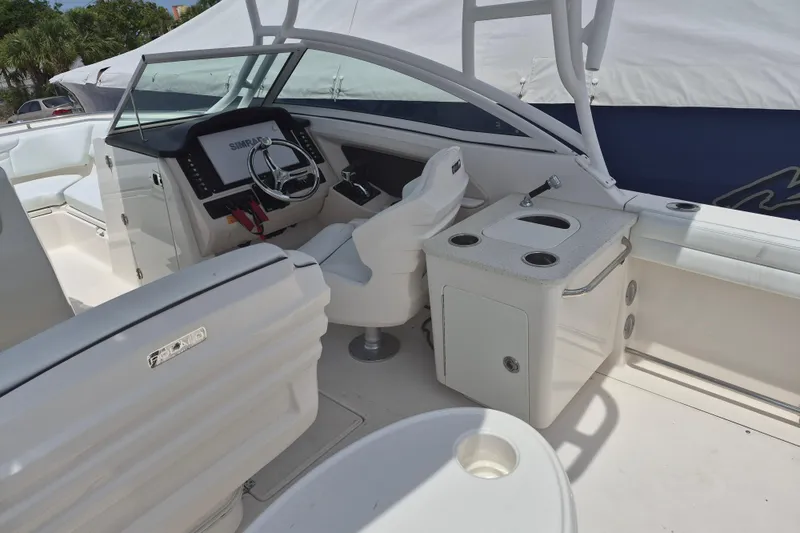 Slide: The Image of 2021 Robalo R247 Dual Console boat interior with helm, seating, and sink station. - 11