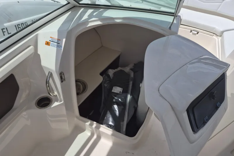 Slide: The Image of 2021 Robalo R247 Dual Console boat interior storage compartment with open hatch. - 12
