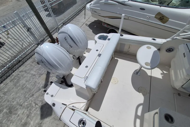 Slide: The Image of 2021 Robalo R247 Dual Console boat with twin Yamaha engines, docked outdoors. - 16
