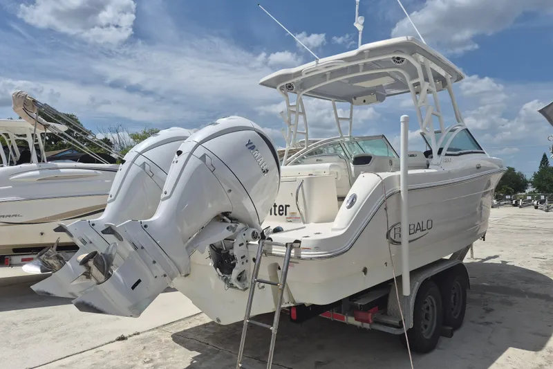 Slide: The Image of 2021 Robalo R247 Dual Console boat with twin Yamaha engines on a trailer. - 3