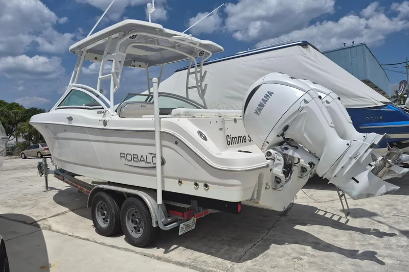 Slide: The Image of 2021 Robalo R247 Dual Console boat on trailer with Yamaha outboard motor. - 4