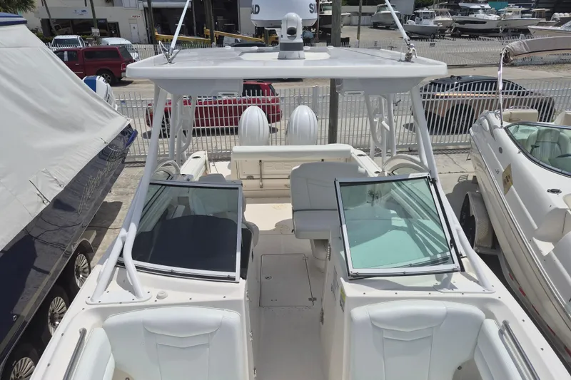 Slide: The Image of 2021 Robalo R247 Dual Console boat with open deck and seating, docked at marina. - 7