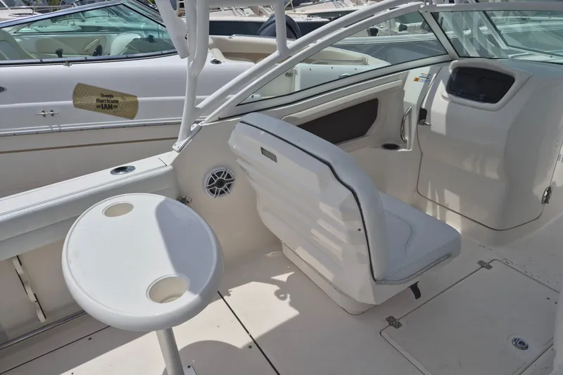 Slide: The Image of 2021 Robalo R247 Dual Console boat interior with seating and table. - 9