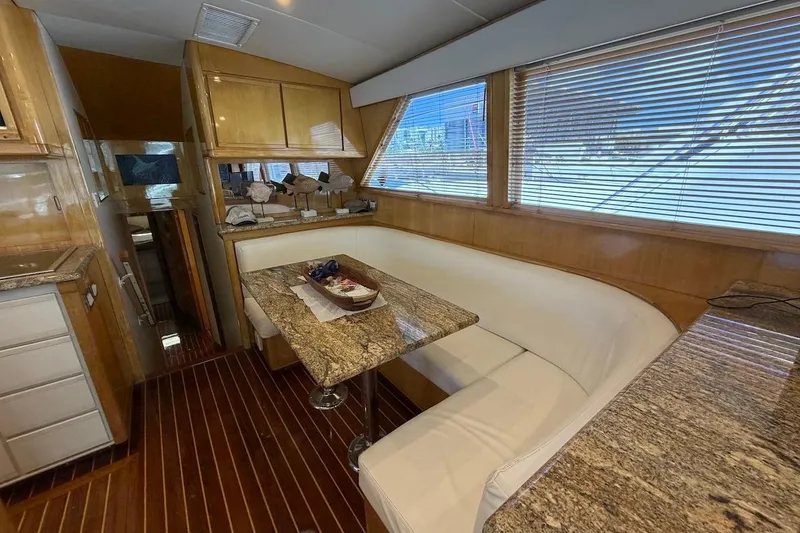 Slide: The Image of Interior of a 1995 Bertram 60 Convertible yacht with elegant wood and granite finishes. - 20