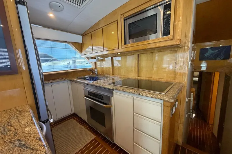 Slide: The Image of Luxurious kitchen interior of a 1995 Bertram 60 Convertible yacht with modern appliances. - 23