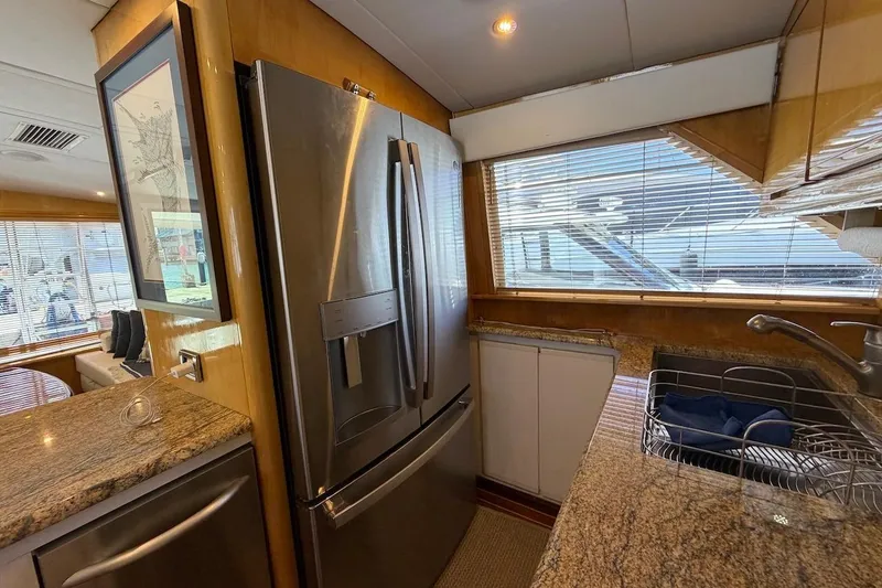 Slide: The Image of Luxurious kitchen interior of 1995 Bertram 60 Convertible yacht with stainless steel appliances. - 24