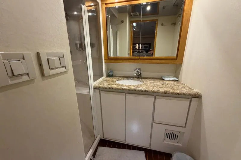 Slide: The Image of Bathroom interior of 1995 Bertram 60 Convertible yacht with granite countertop and mirror. - 31