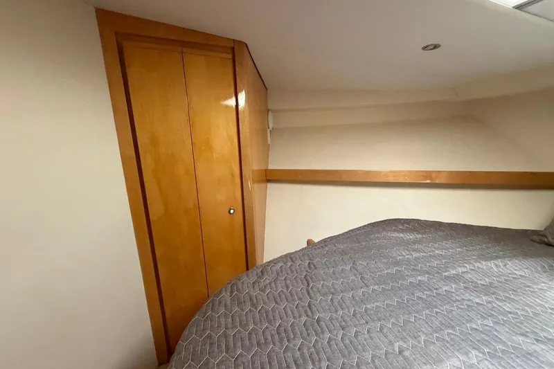 Slide: The Image of Interior cabin of 1995 Bertram 60 Convertible yacht with wooden closet and bed. - 35