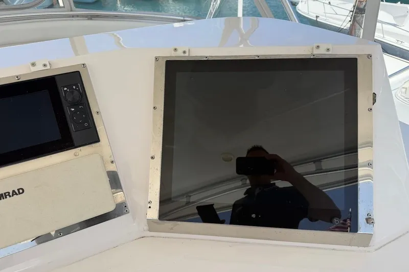 Slide: The Image of Control panel on a 1995 Bertram 60 Convertible yacht, featuring navigation equipment. - 36