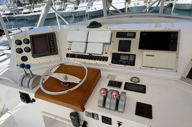 Slide: The Image of Control panel of a 1995 Bertram 60 Convertible yacht with navigation instruments. - 39