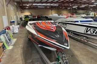 The Image of 2021 Velocity 290 Sport Cruiser with vibrant graphics in a showroom. - 0